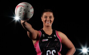 Eleanor Cardwell with a netball - 'Some bigger-chested women wear five sports bras to keep them down'