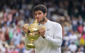 Carlos Alacaraz celebrates with the Wimbledon men's singles trophy