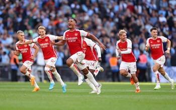 Arsenal celebrate beating Manchester City in a penalty shoot-out at Wembley Stadium on Sunday - Arsenal beat Manchester City in penalty shoot-out to win Community Shield