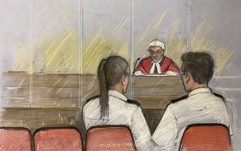 A court drawing of Mr Justice Goss addressing the dock containing two dock officers beside empty seats during the sentencing of Lucy Letby at Manchester Crown Court 
