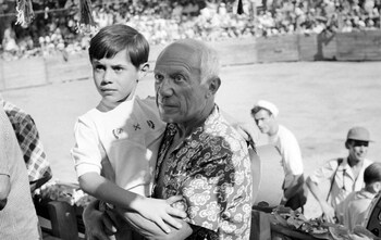 Seven-year-old Claude with his father Pablo Picasso in 1954, at a bullfight in the south of France