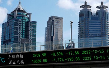 An electronic board shows Shanghai and Shenzhen stock indexes, at the Lujiazui financial district in Shanghai, China