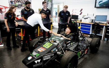 Rishi Sunak views the build of an electric racing car and talks with the student racing team during his visit to the International Manufacturing Centre at the University of Warwick this morning 